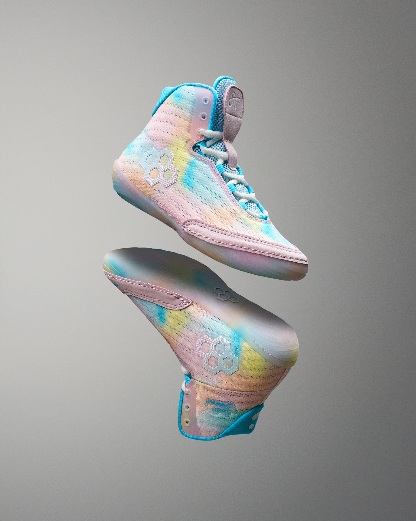Colorful Wrestling shoes with a gradient design on a gray background