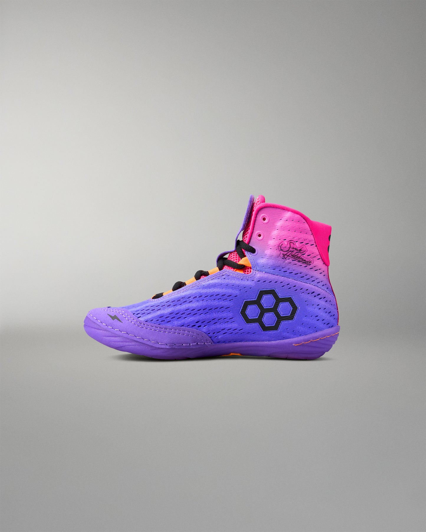 Purple and pink wrestling shoe with a brand logo on a gray background