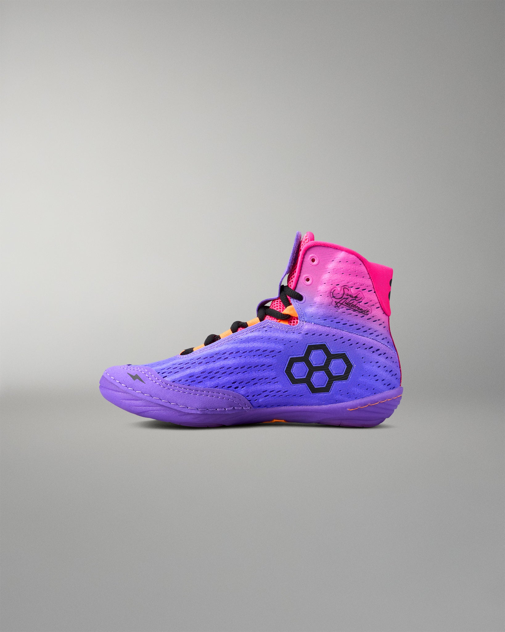 Purple and pink wrestling shoe with a brand logo on a gray background