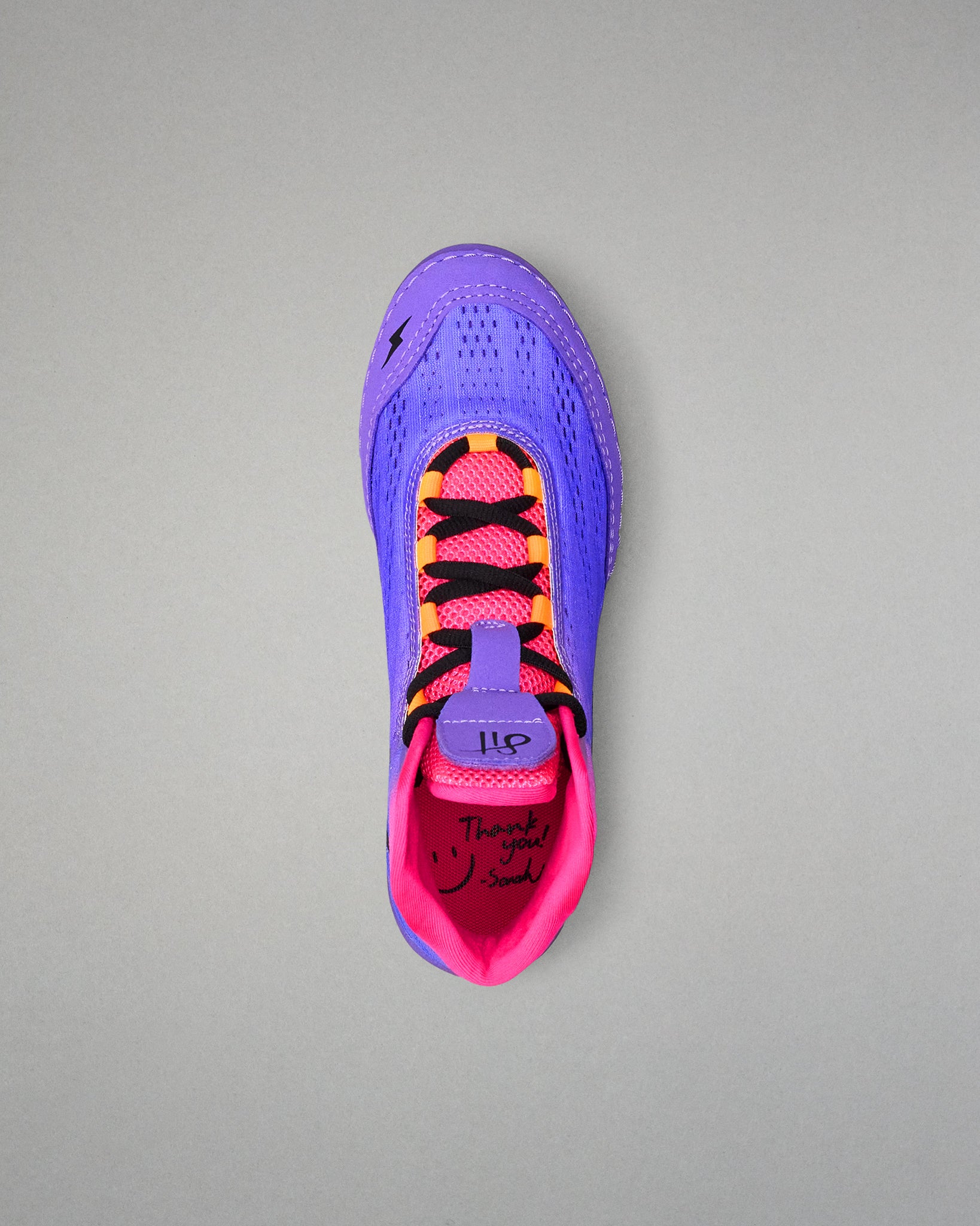 Purple and pink wrestling shoe with black accents on a gray background