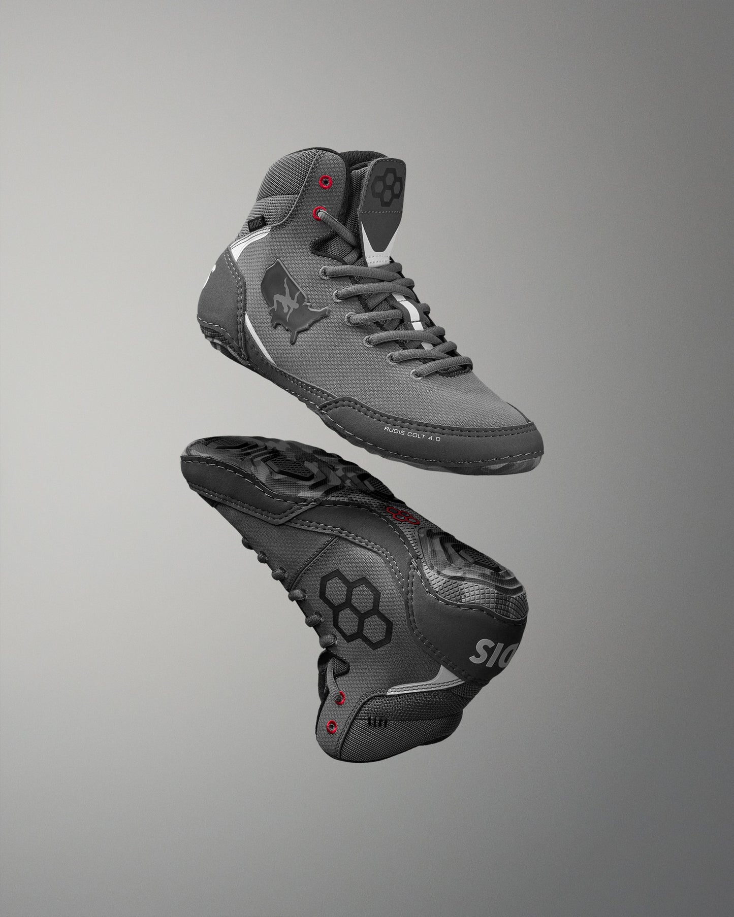 Gray wrestling shoes with black soles on a gray background