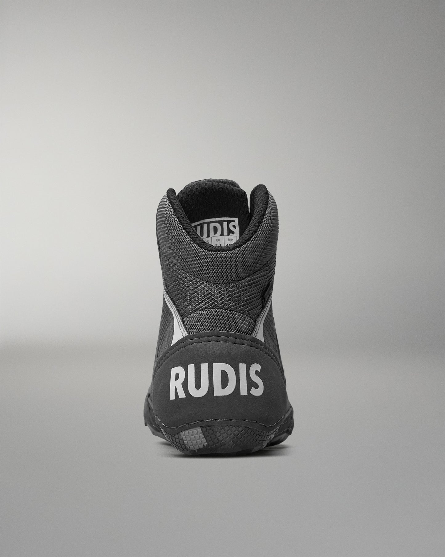 Gray wrestling shoe with 'RUDIS' branding on a gray background