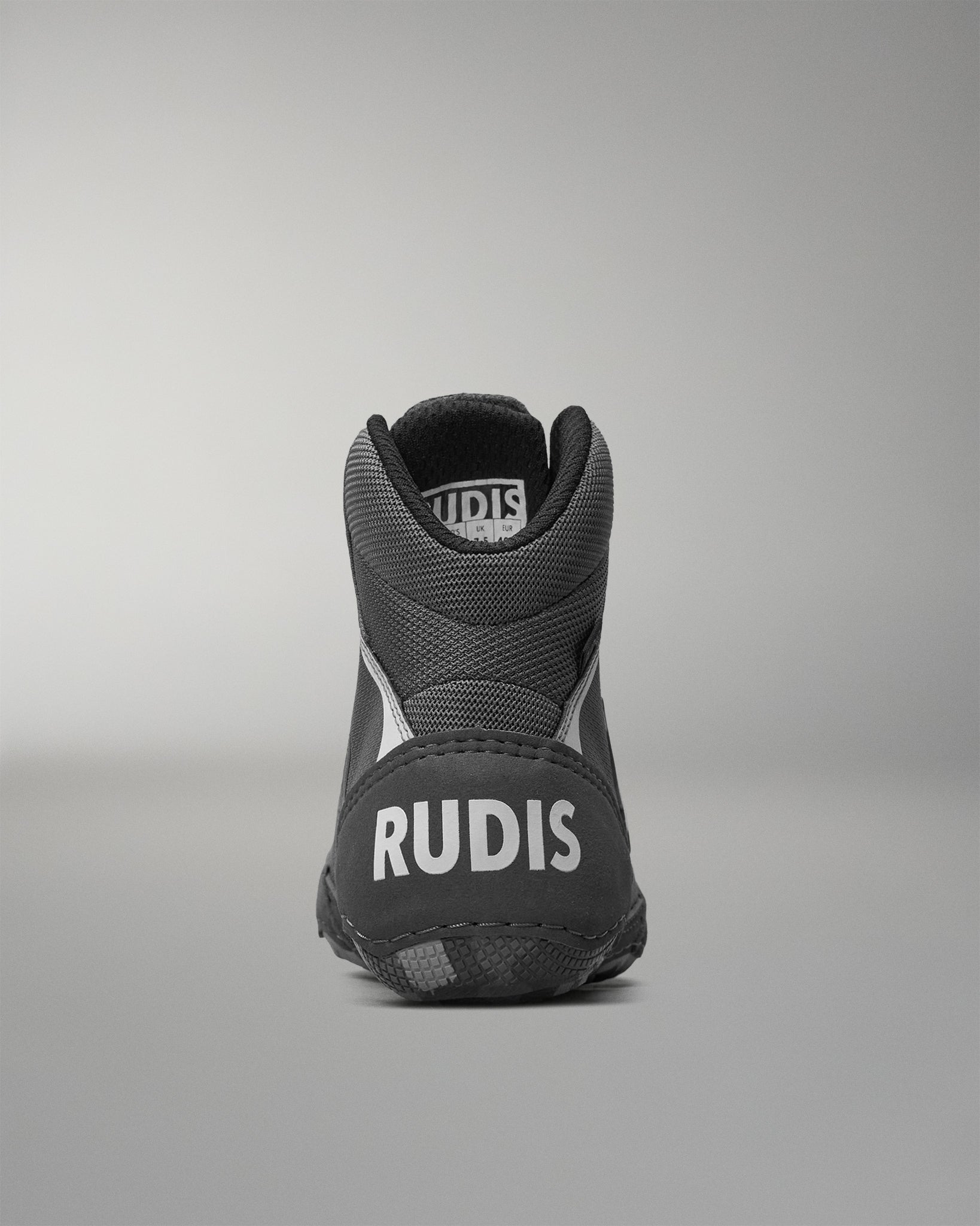 Gray wrestling shoe with 'RUDIS' branding on a gray background