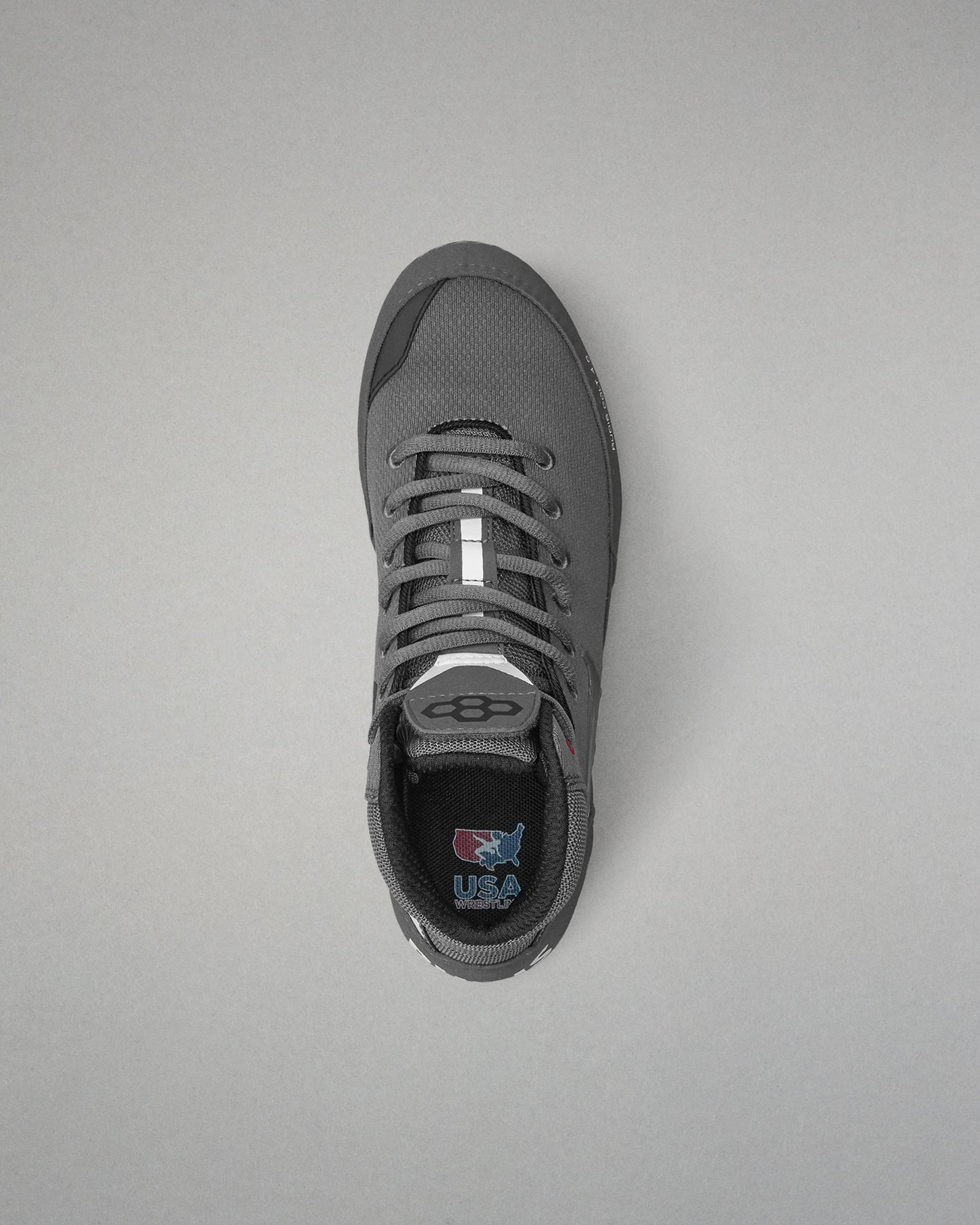 Gray wrestling shoe on a light gray background