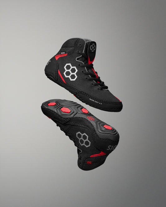 Black RUDIS Wrestling shoe with red accents on a gray background