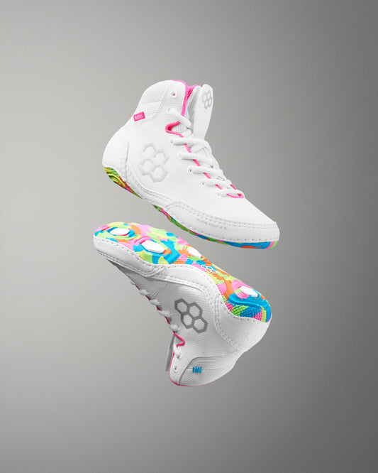 White wrestling shoes with colorful soles on a gray background