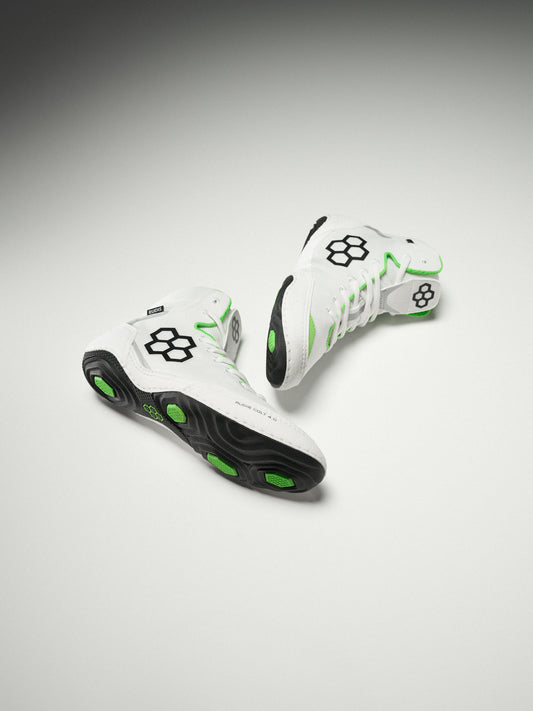 White wrestling shoes with black and green accents on a gray background