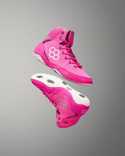 Pink high-top sneakers with a white logo on a gray background