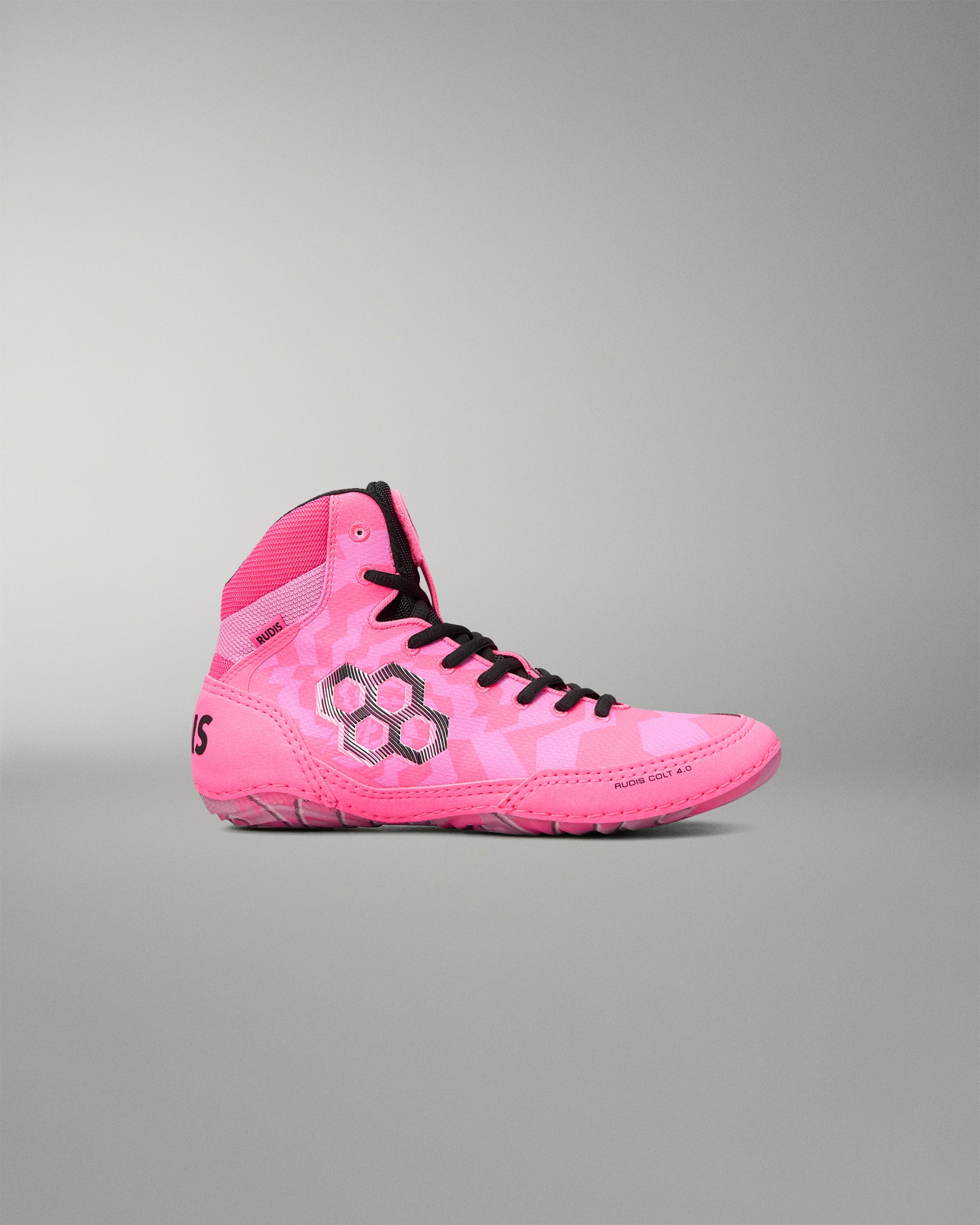 A single high-top Wrestling shoe in vibrant pink with a subtle tonal geometric pattern, black laces, and a black hexagonal logo on the side, set against a solid gray background.