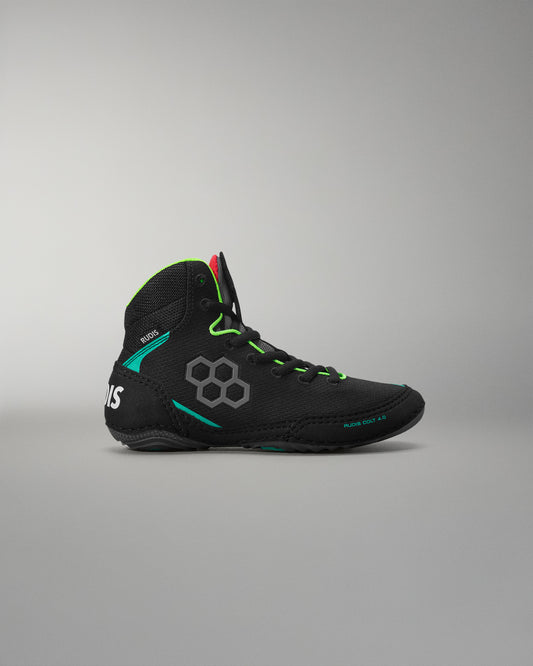 Black wrestling shoe with green accents on a gray background