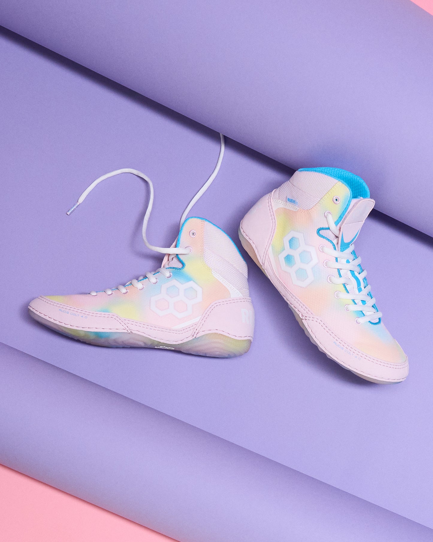 Colorful Wrestling shoes on a two-tone purple and pink background