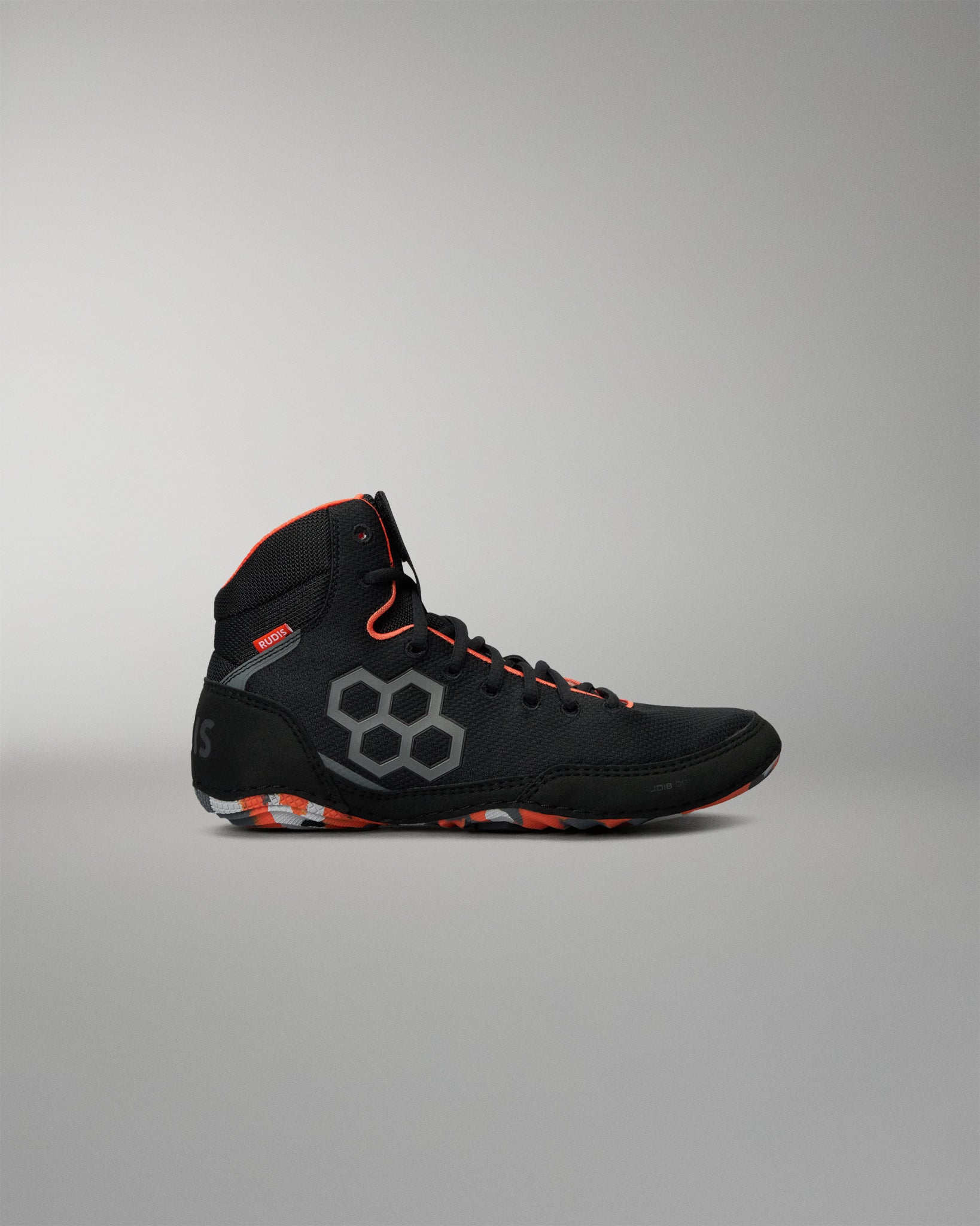 A high-top black Wrestling Shoe with gray geometric side detailing and bright orange accents on the collar, laces, and outsole, shown against a neutral gray background.