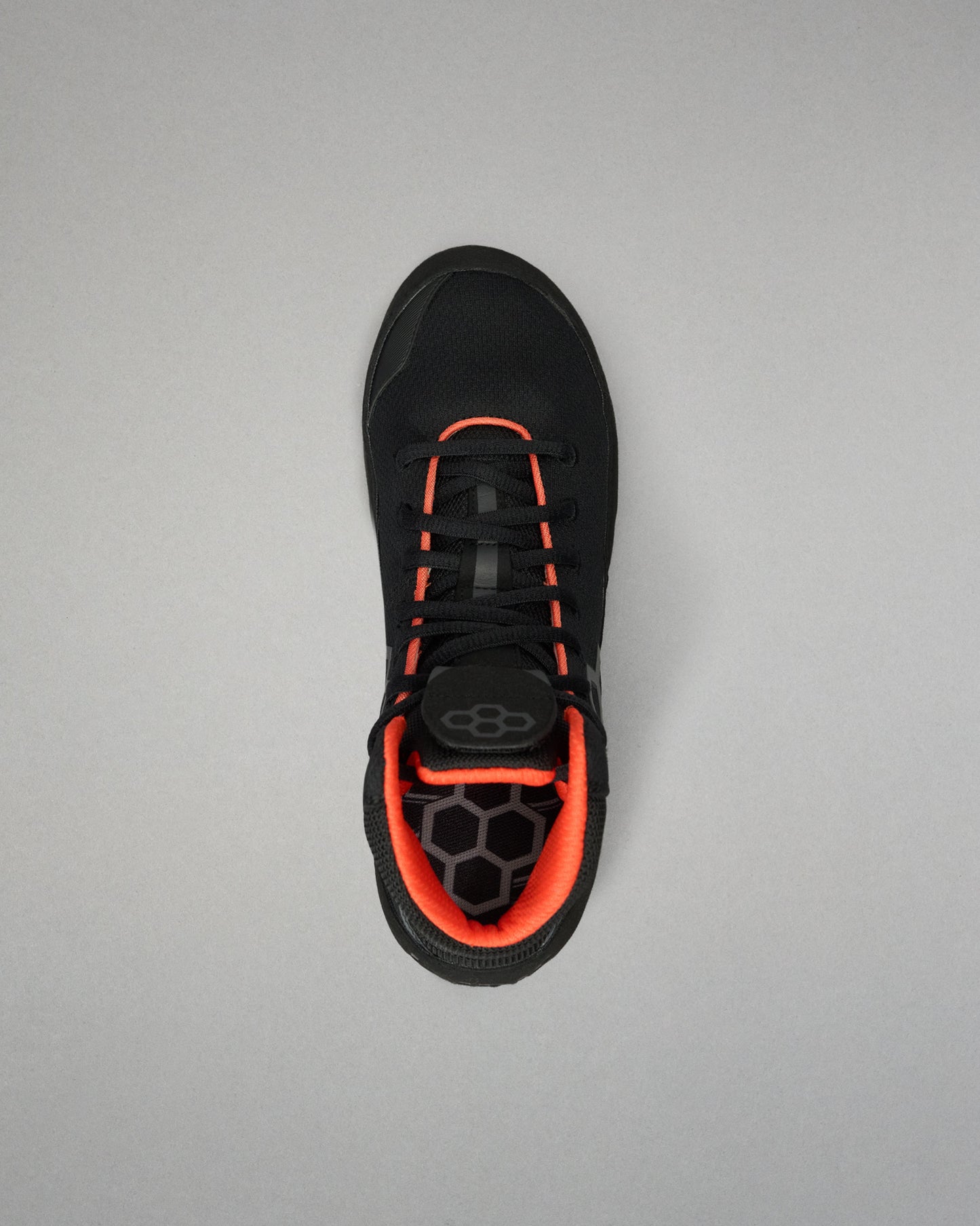 A black Wrestling Shoe with vibrant orange accents, shown from a top-down view on a neutral gray background.