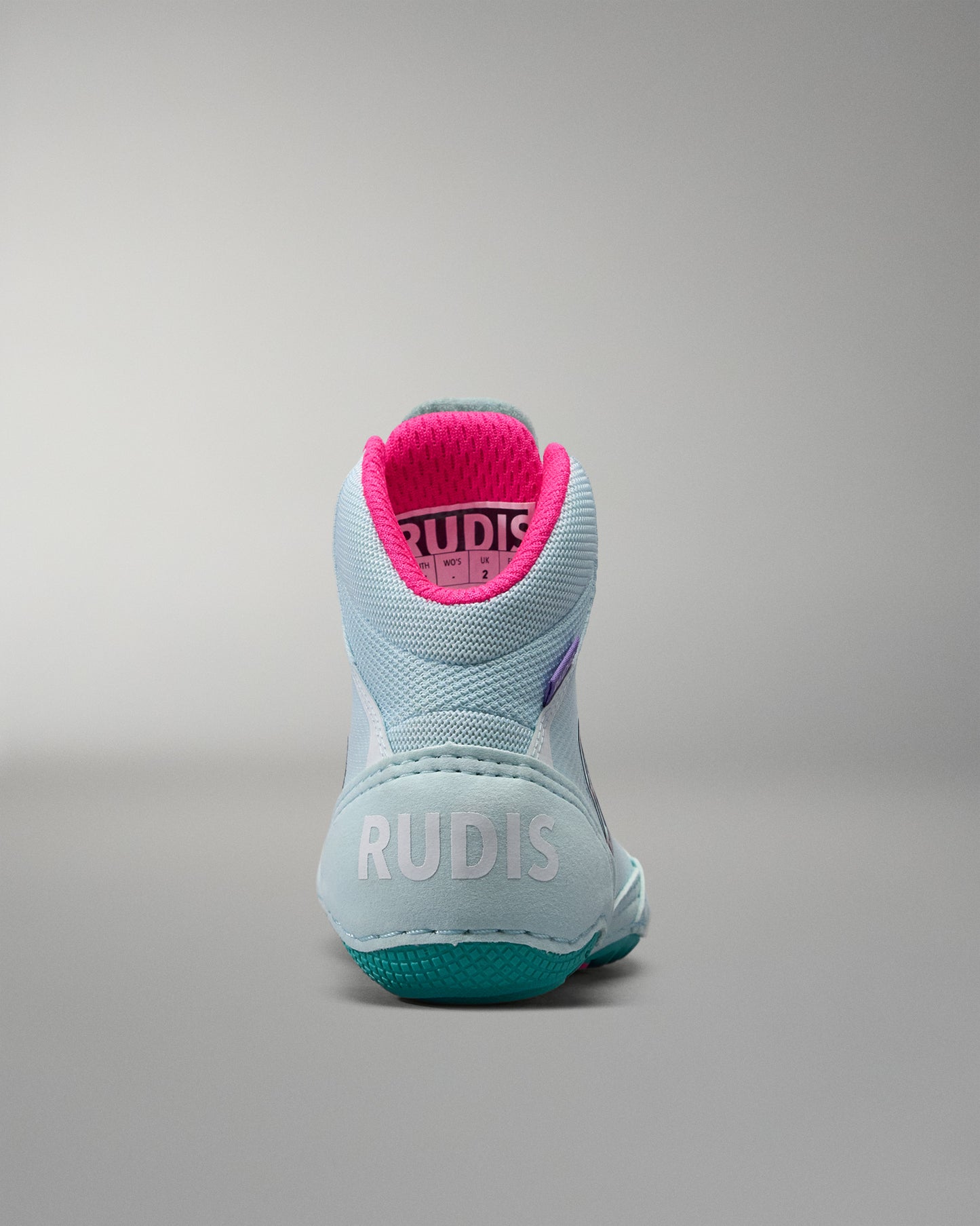 Light blue athletic shoe with pink interior on a gray background