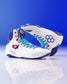 White USA Wrestling Shoes with blue and red accents on a reflective surface with a blue background