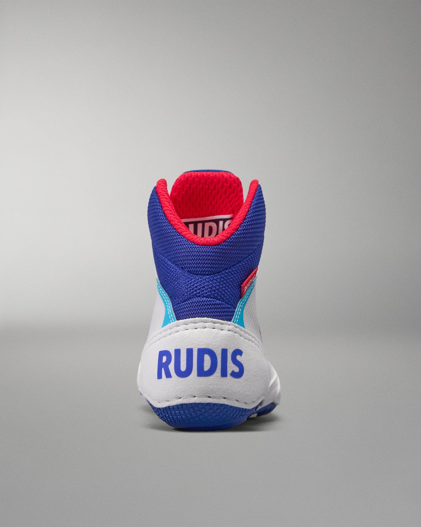 Blue and white USA Wrestling shoe with red accents on a gray background