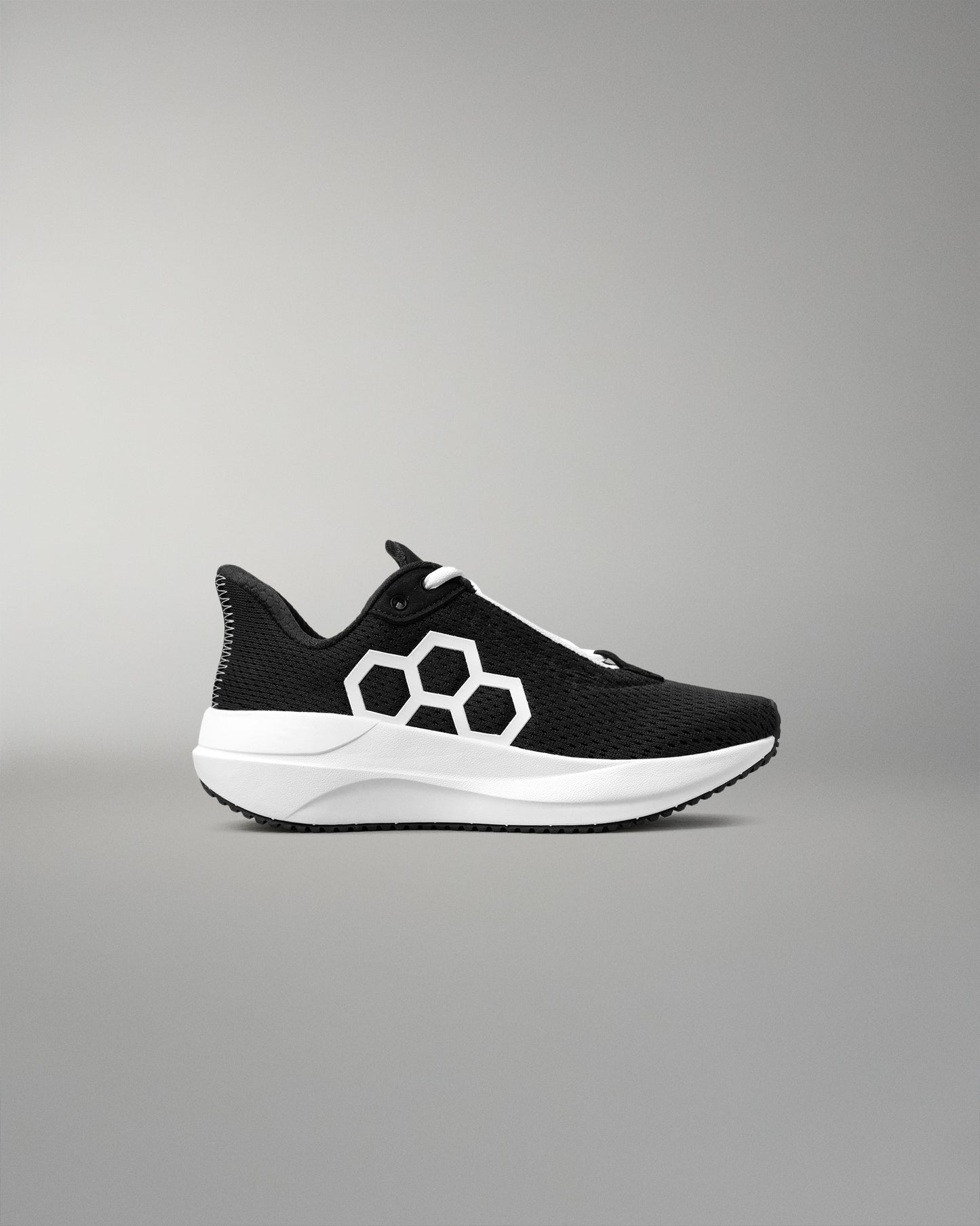 Black and white sneaker with a geometric design on a gray background