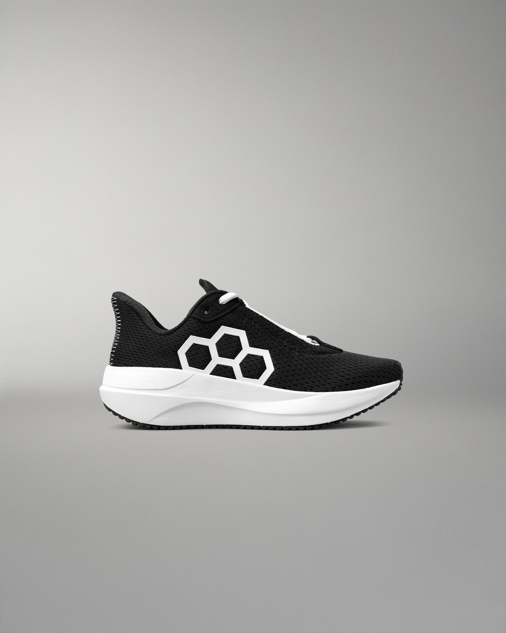 Black and white sneaker with a geometric design on a gray background