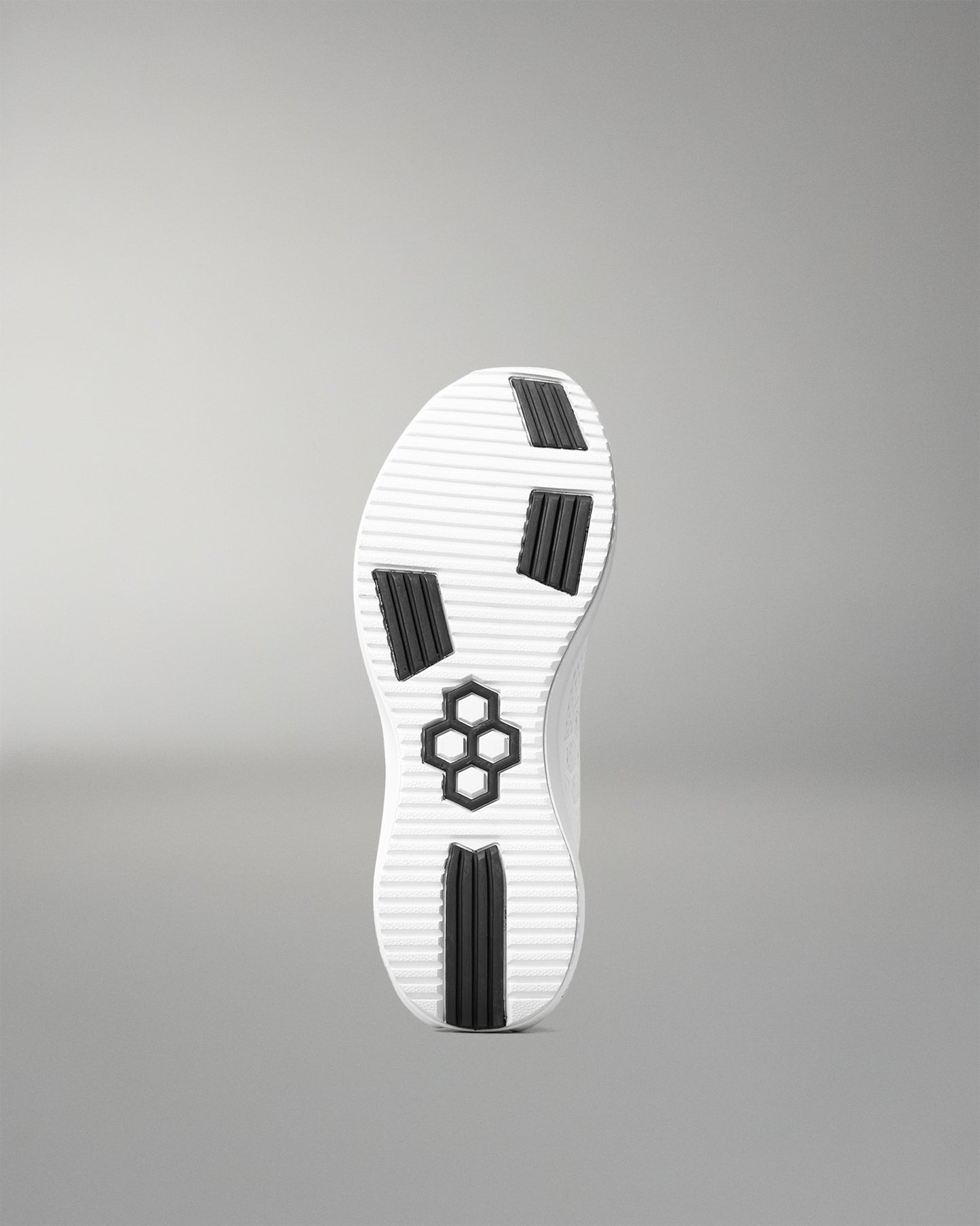 White shoe sole with black accents on a gray background