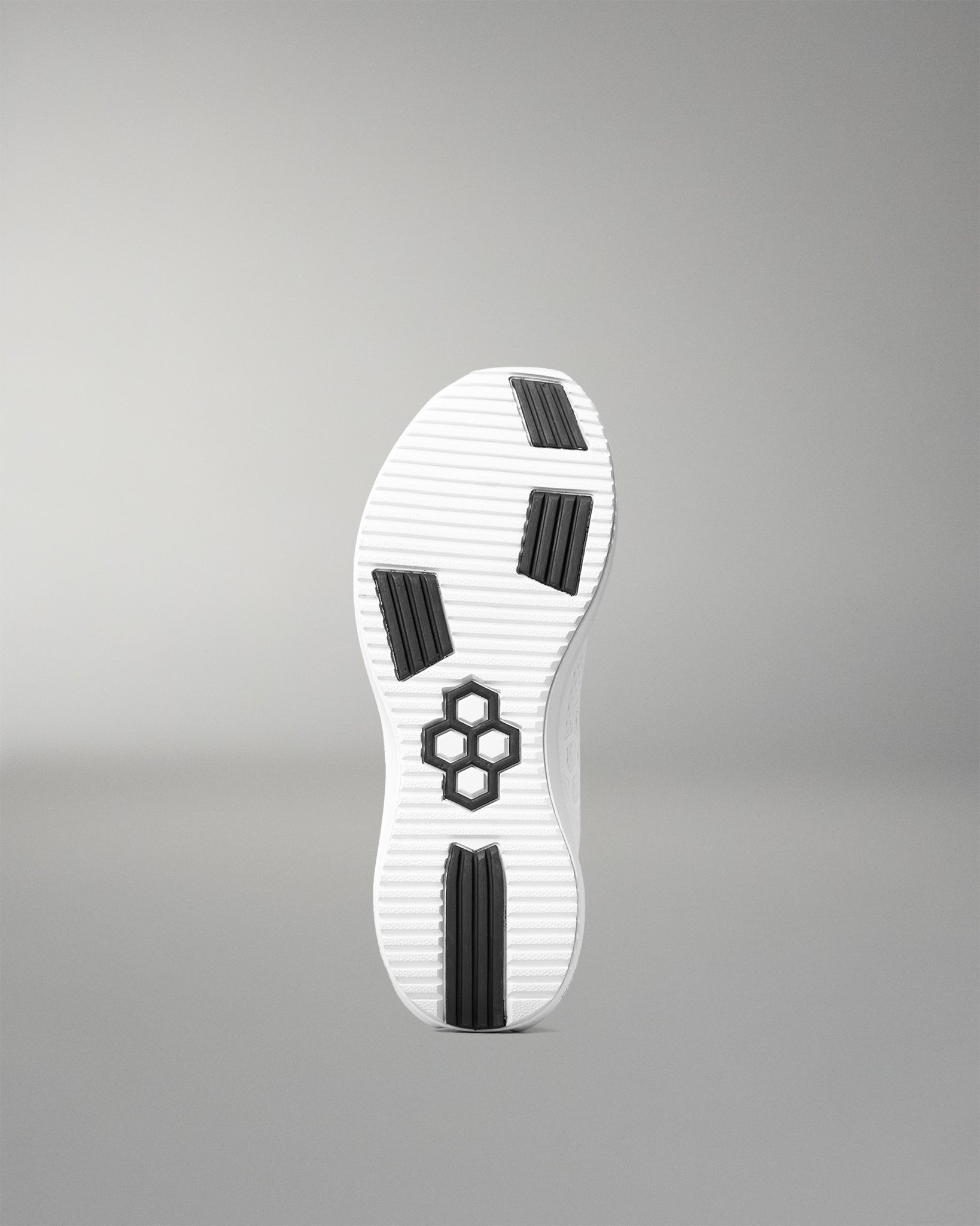 White shoe sole with black accents on a gray background