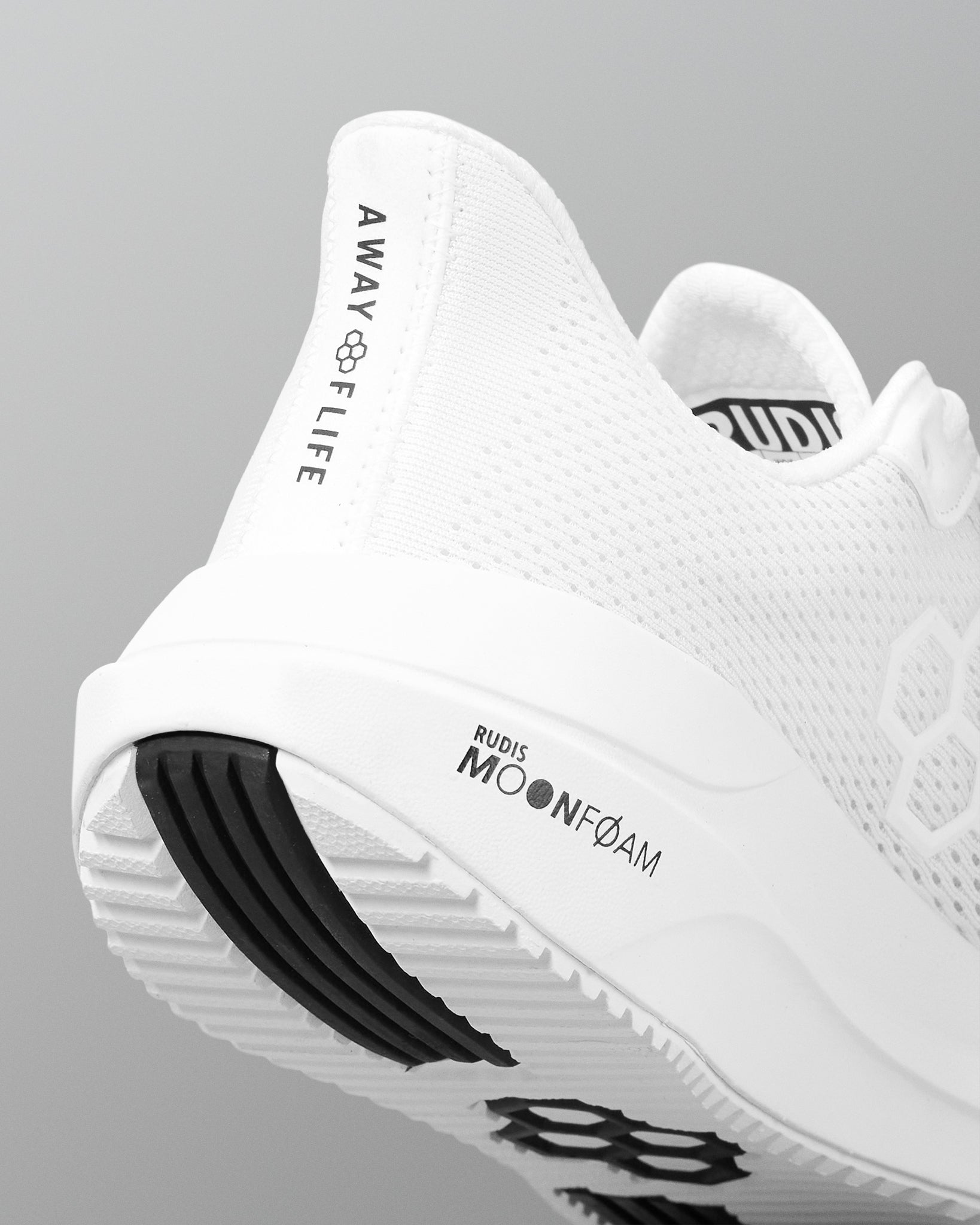 White athletic shoe with branding on a gray background