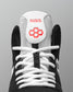 Close-up of the RUDIS Courage 2.0 Youth Wrestling Shoe tongue featuring breathable white mesh, embroidered RUDIS branding, and white performance laces.