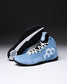A pair of light blue high-top wrestling shoe with white laces, a white geometric side logo, and a black sole, photographed on a dark-to-light gray gradient studio background.