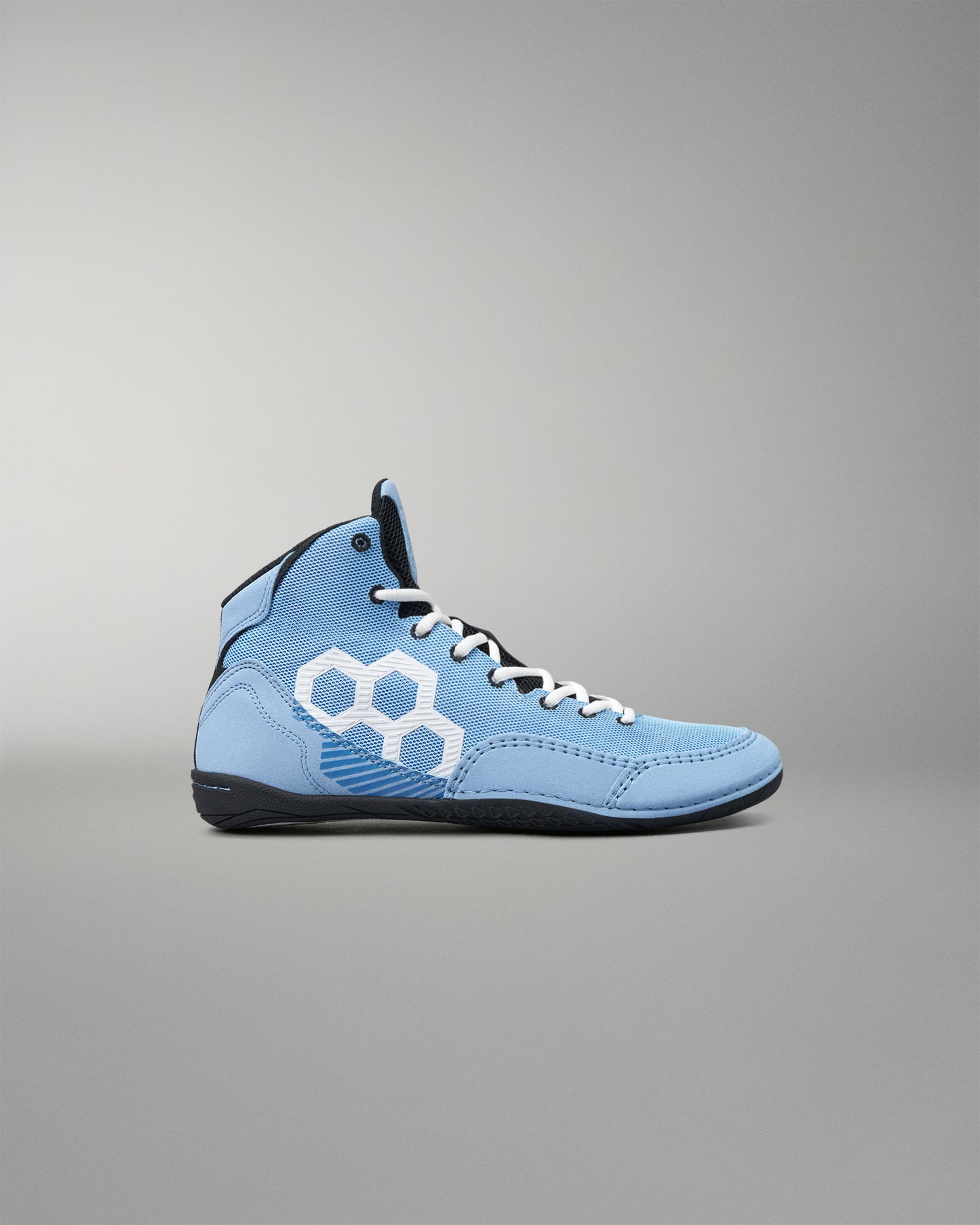 A light blue high-top athletic wrestling shoe with a white geometric hexagon logo on the side, white laces, and a black sole, shown against a neutral gray background.