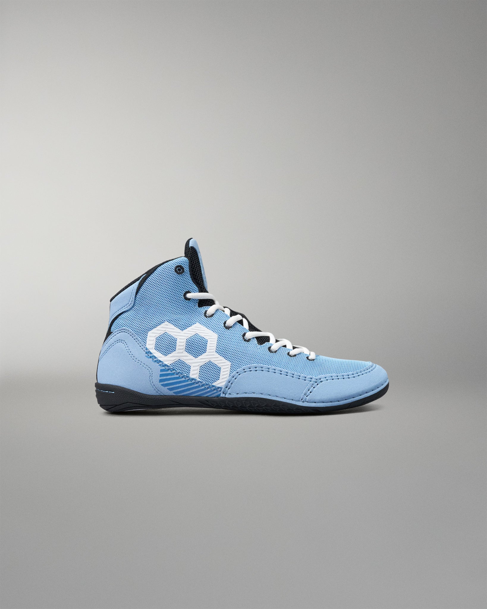 A light blue high-top athletic wrestling shoe with a white geometric hexagon logo on the side, white laces, and a black sole, shown against a neutral gray background.