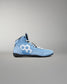 A light blue high-top athletic wrestling shoe with a white geometric hexagon logo on the side, white laces, and a black sole, shown against a neutral gray background.