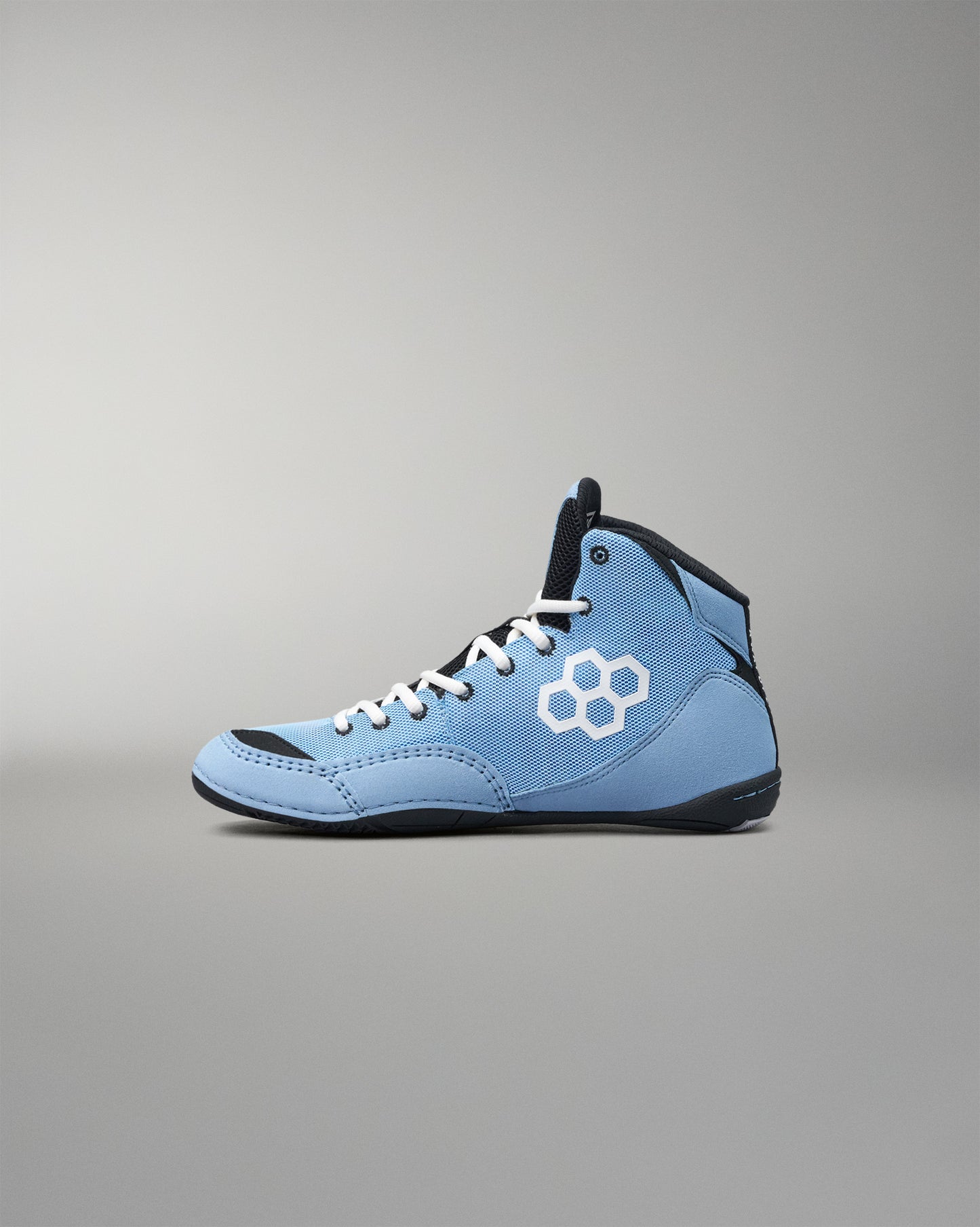 A light blue high-top wrestling shoe with white laces, a white geometric logo on the side, and black accents on the collar, tongue, and sole, shown against a neutral gray background.
