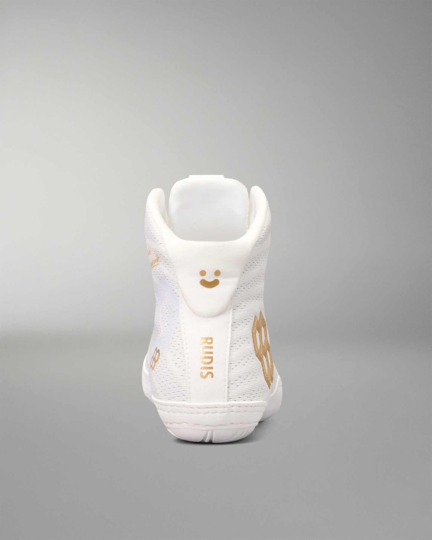 A white high-top wrestling shoe shown from the back, featuring gold-colored graphic details, including a smiley face, the brand name 'RIMIS', and a large gold number '8'.