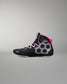 A high-top wrestling shoe in black with a bright pink collar lining, white and gray geometric side patterns, and white laces, shown against a neutral gray background.
