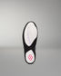 The outsole of a black and white wrestling shoe, featuring a white tread pattern with a pink flower logo on the heel, shown against a neutral gray background.
