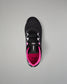 A black wrestling shoe with bright pink lining and white laces, shown from a top-down view on a neutral gray background.