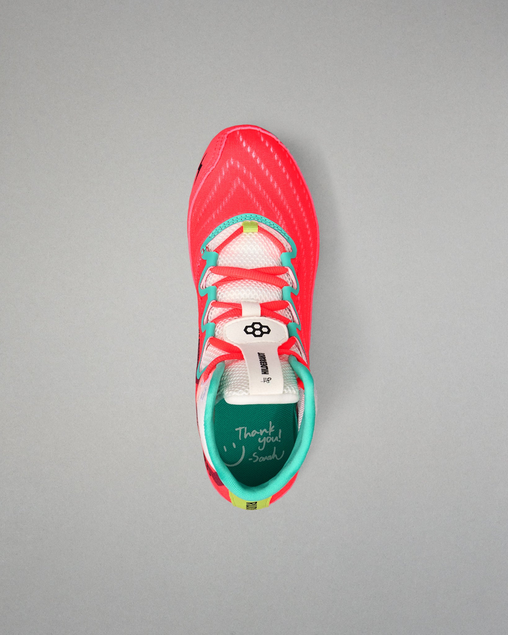 Top view of the RUDIS Hildebrandt 2.0 Girls Wrestling Shoe with coral laces, teal trim, white tongue, and signature insole detail.