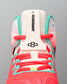 Close-up of the RUDIS Hildebrandt 2.0 Girls Wrestling Shoe tongue featuring Hildebrandt branding, RUDIS logo, coral laces, and teal supports.