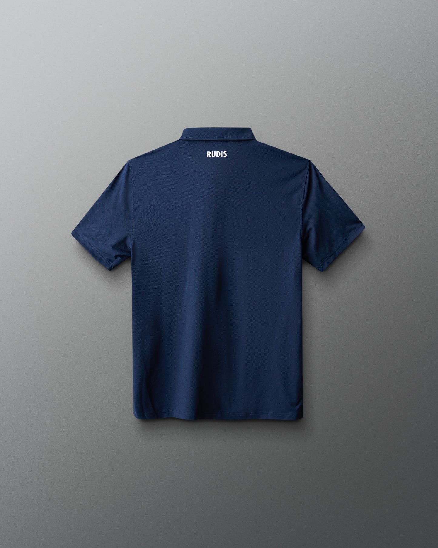 Navy blue polo shirt with 'RUDIS' branding on a gray background