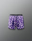 Purple tie-dye shorts with a brand logo on a gray background