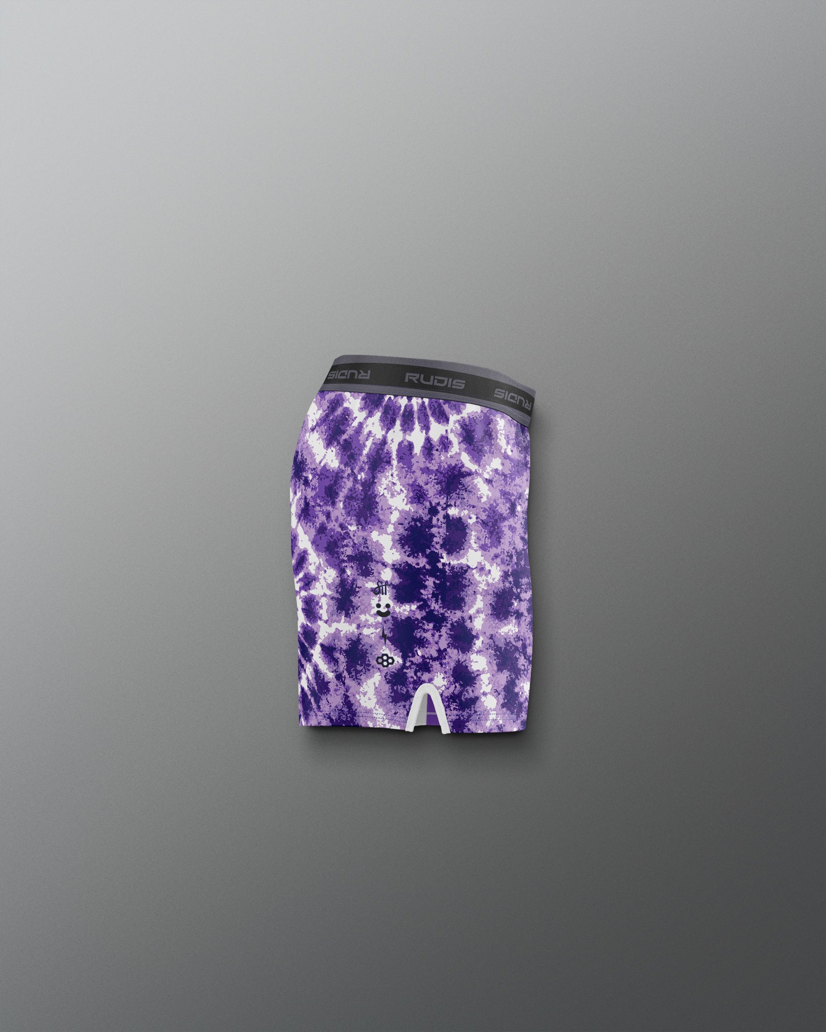 Purple tie-dye athletic shorts on a gray background