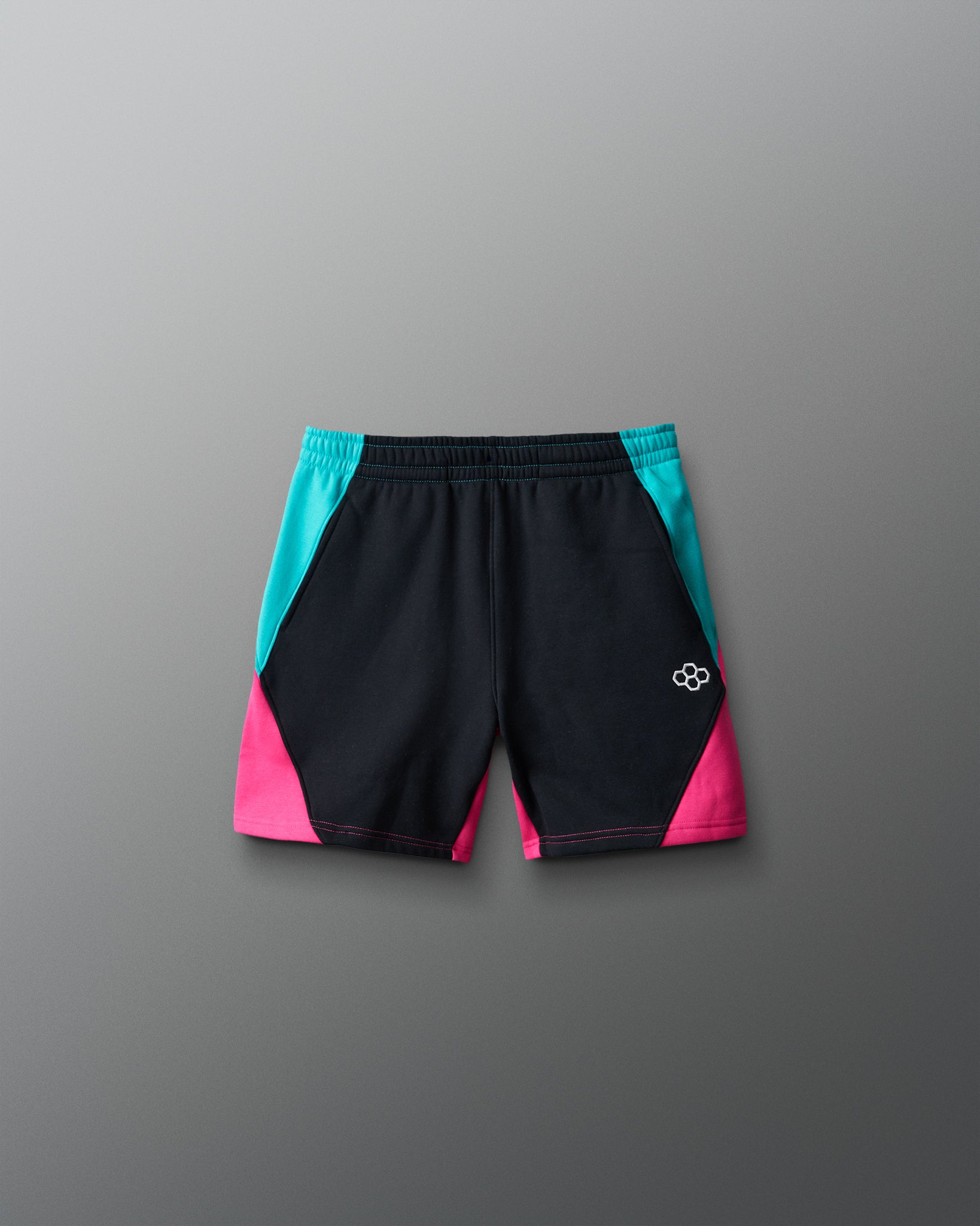 Black shorts with pink and blue accents on a gray background