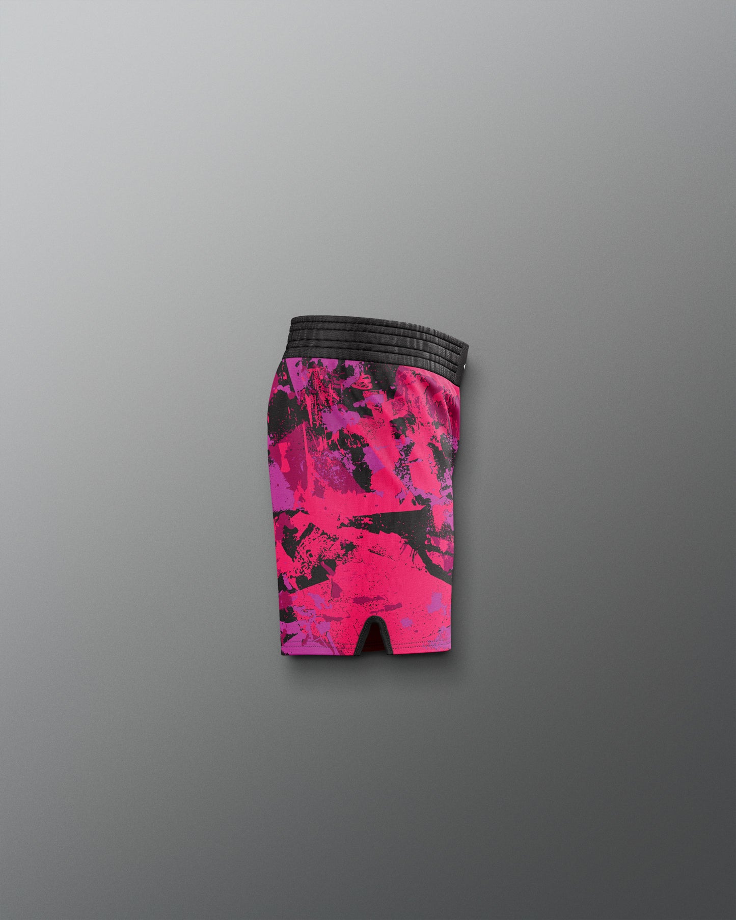 Pink and black patterned shorts on a gray background