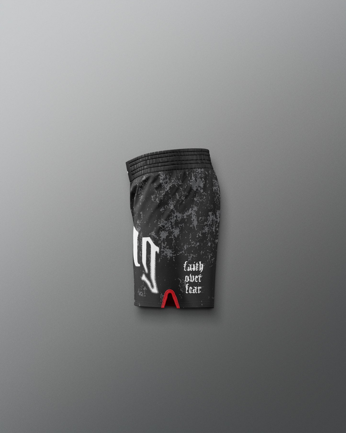 Black athletic shorts with camouflage pattern and text on a gray background