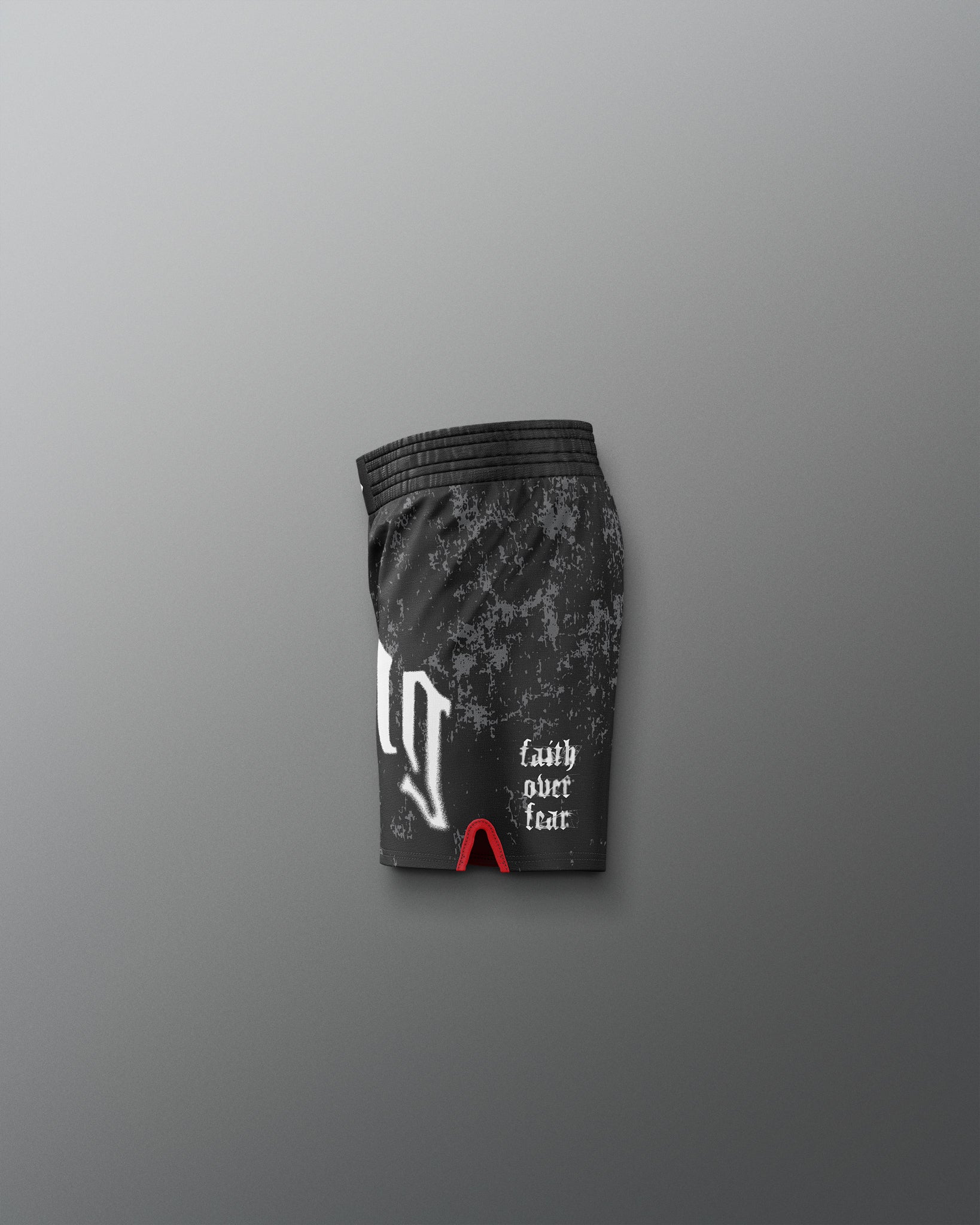 Black athletic shorts with camouflage pattern and text on a gray background