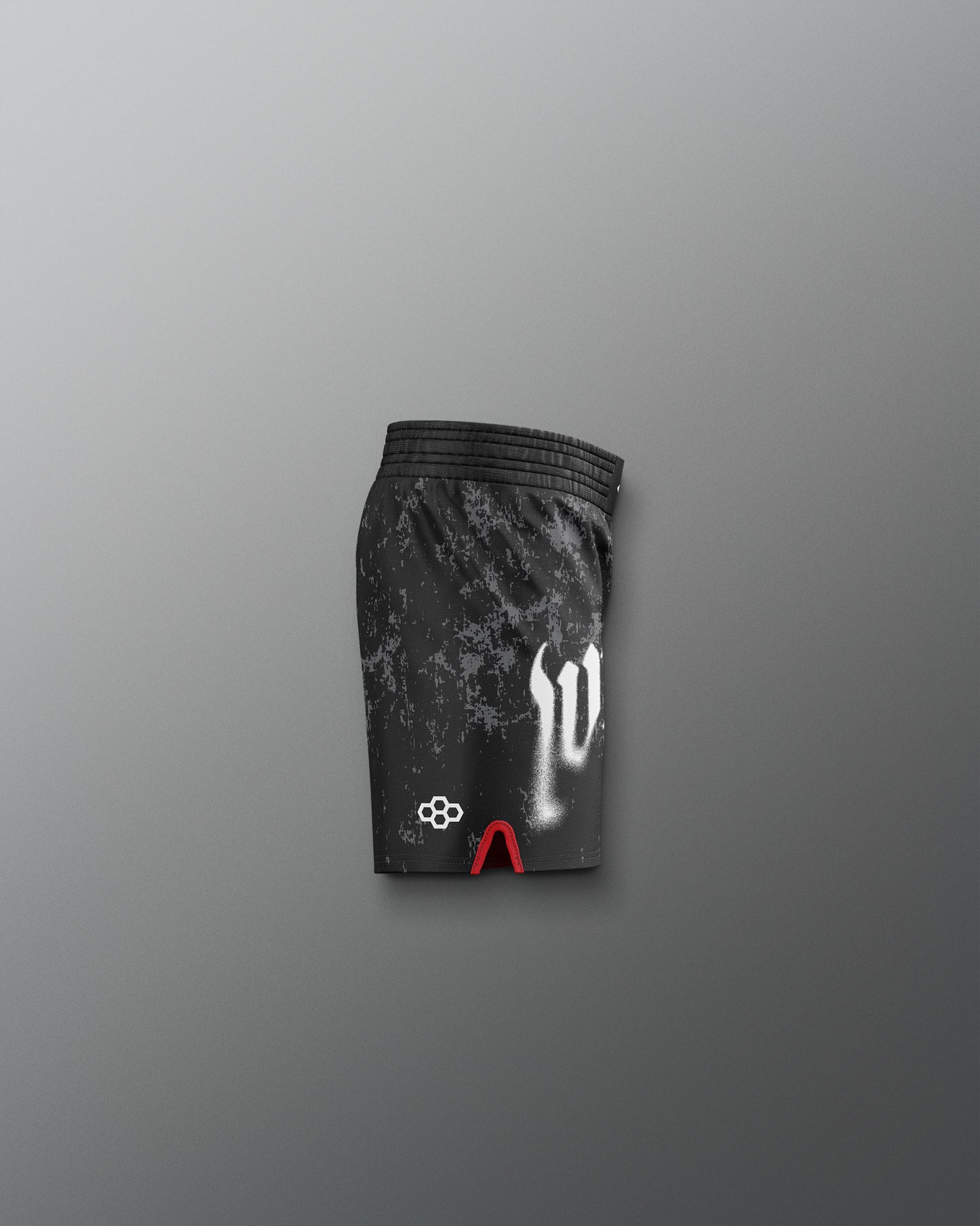Black athletic shorts with white and red designs on a gray background