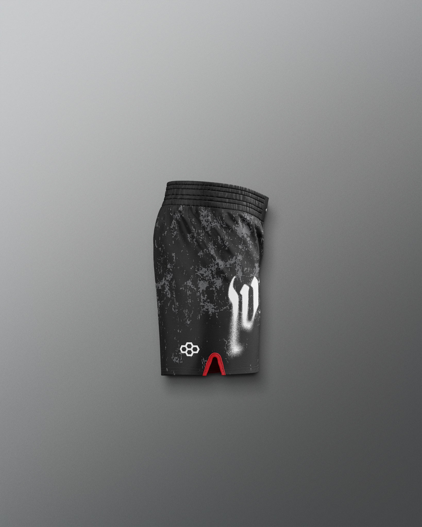 Black athletic shorts with white and red designs on a gray background