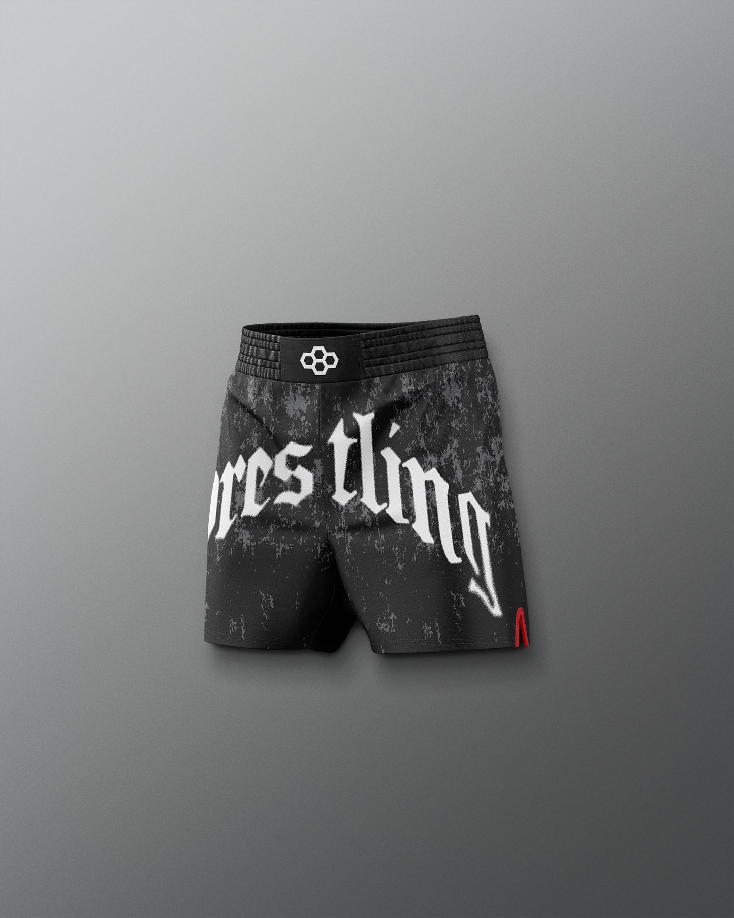 Black wrestling shorts with white text on a gray background