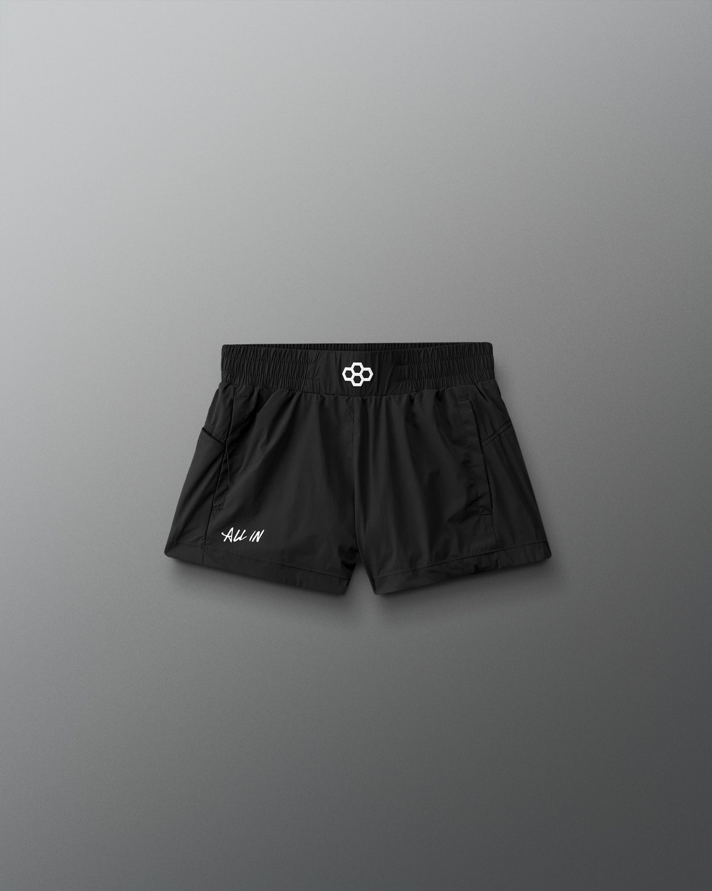 Black shorts with a brand logo on a gray background