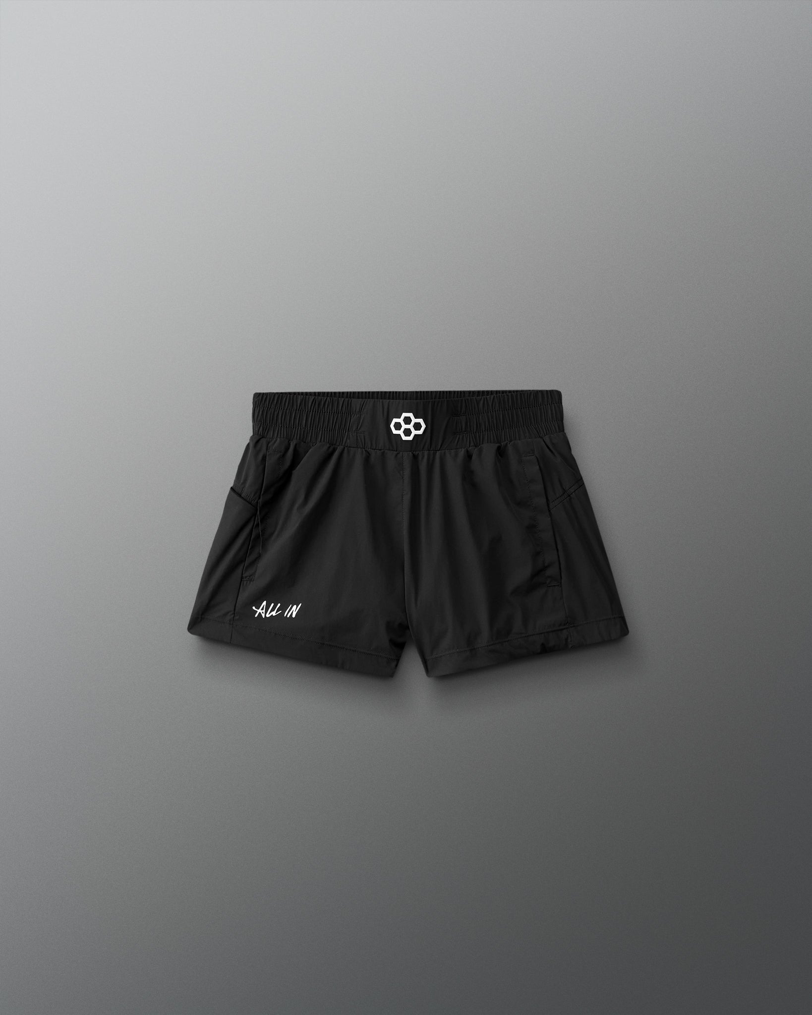 Black shorts with a brand logo on a gray background