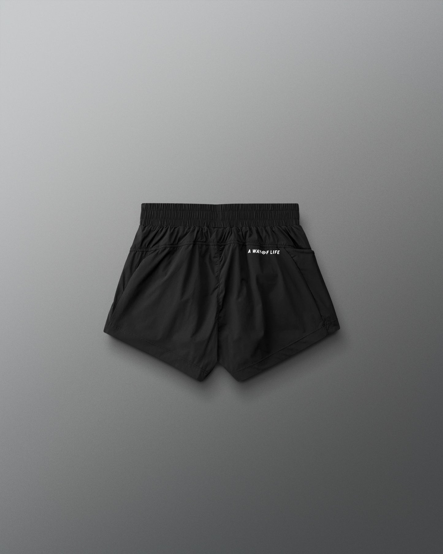 Black shorts with a brand logo on a gray background